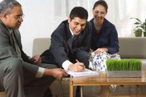 real estate agent sitting with a couple.